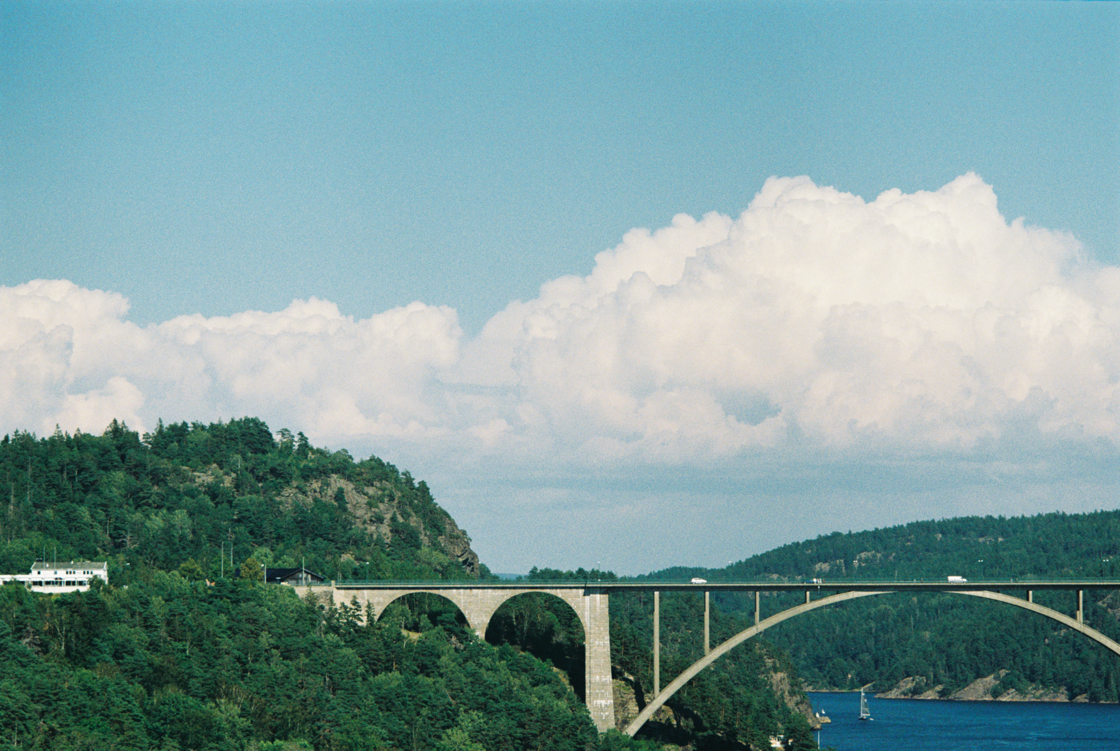 A landscape with a lot of sky and a bridge