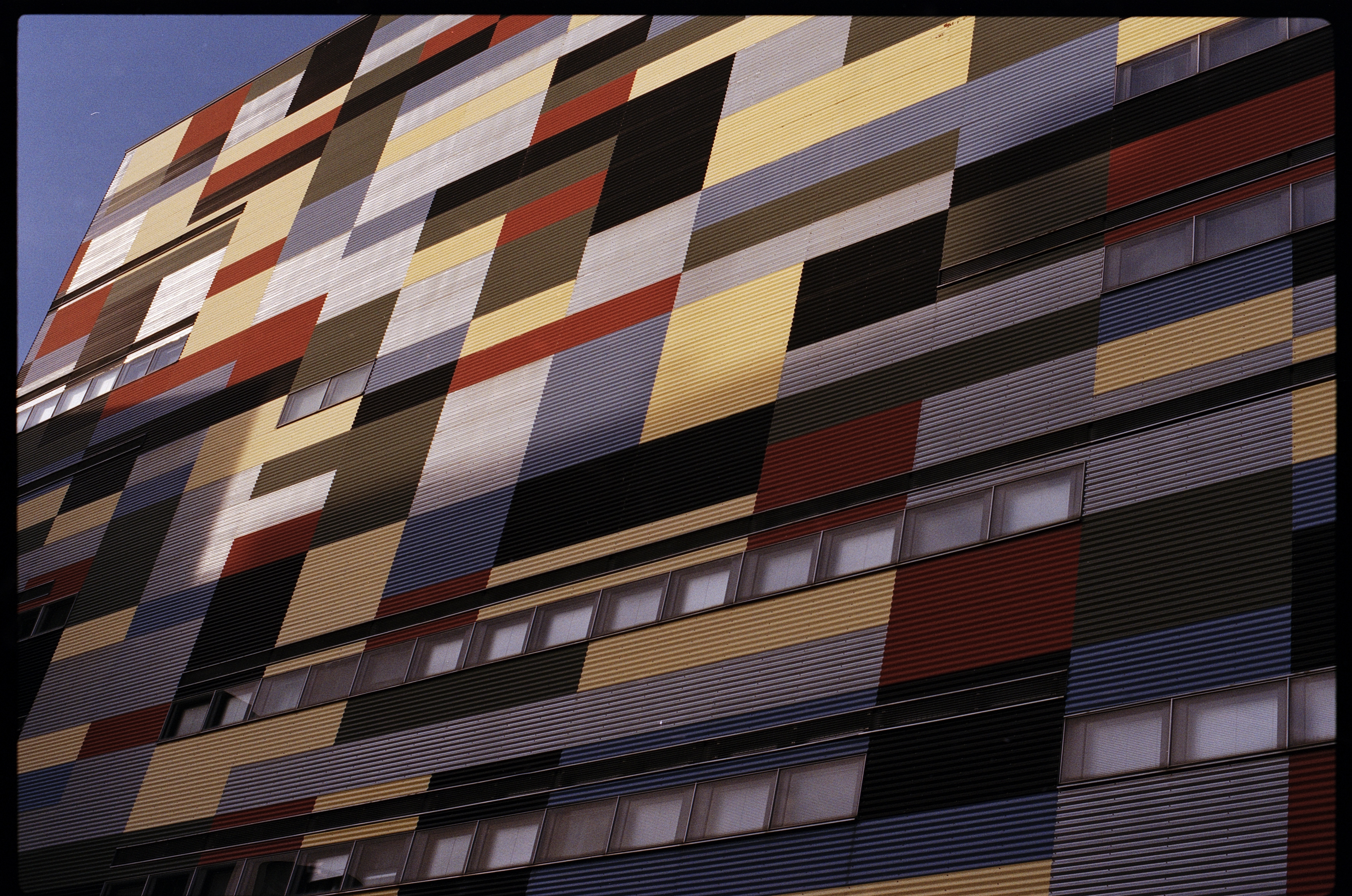 Picture of a corrugated steel wall with colourfull squares